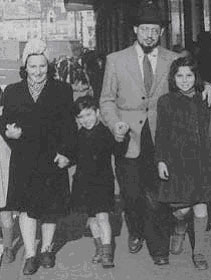 Rabbi Yona Tiefenbrunner and wife Ruth walking with orphans.